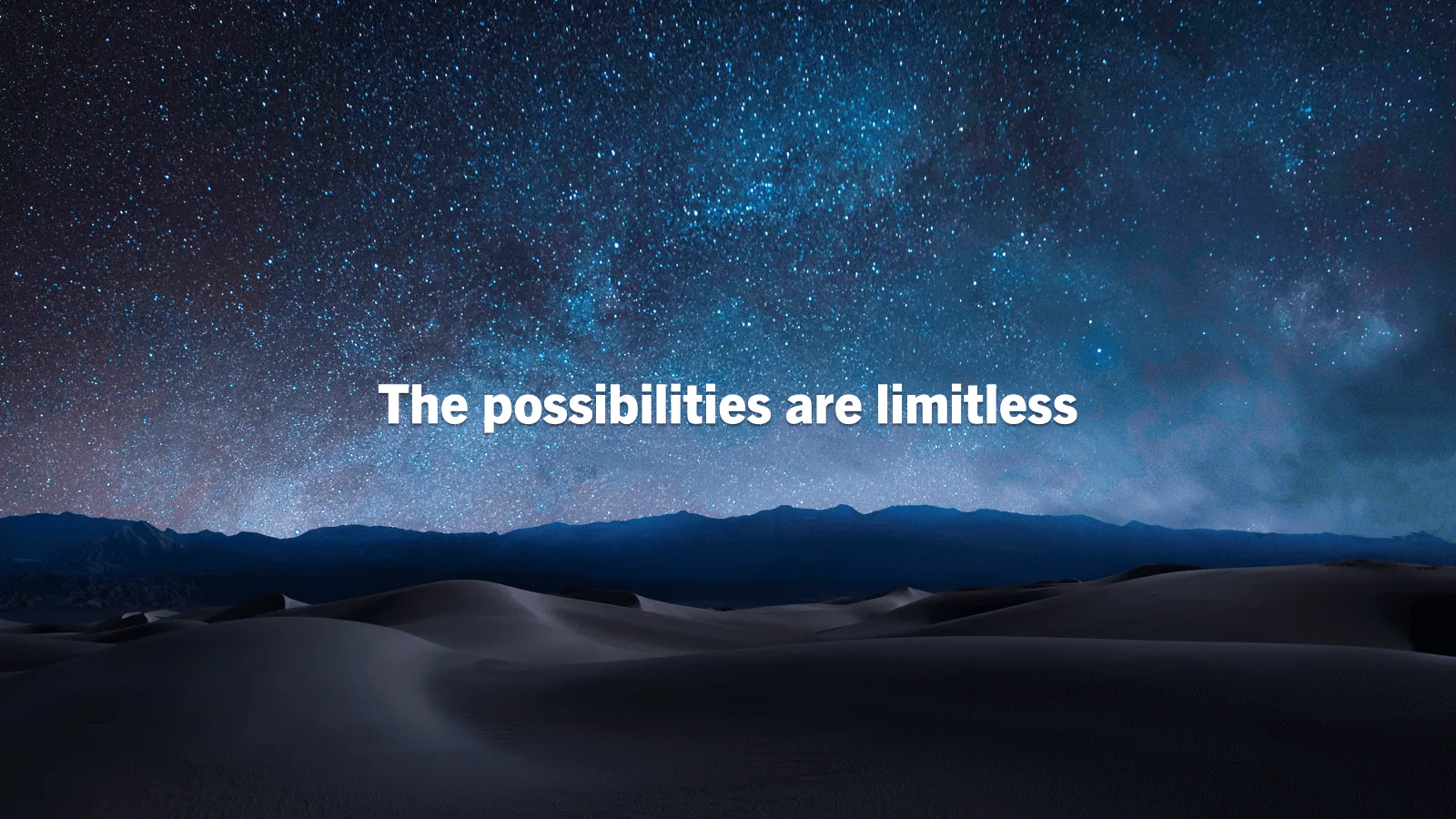 Dark mountains under a starry sky with white text about limitless possibilities